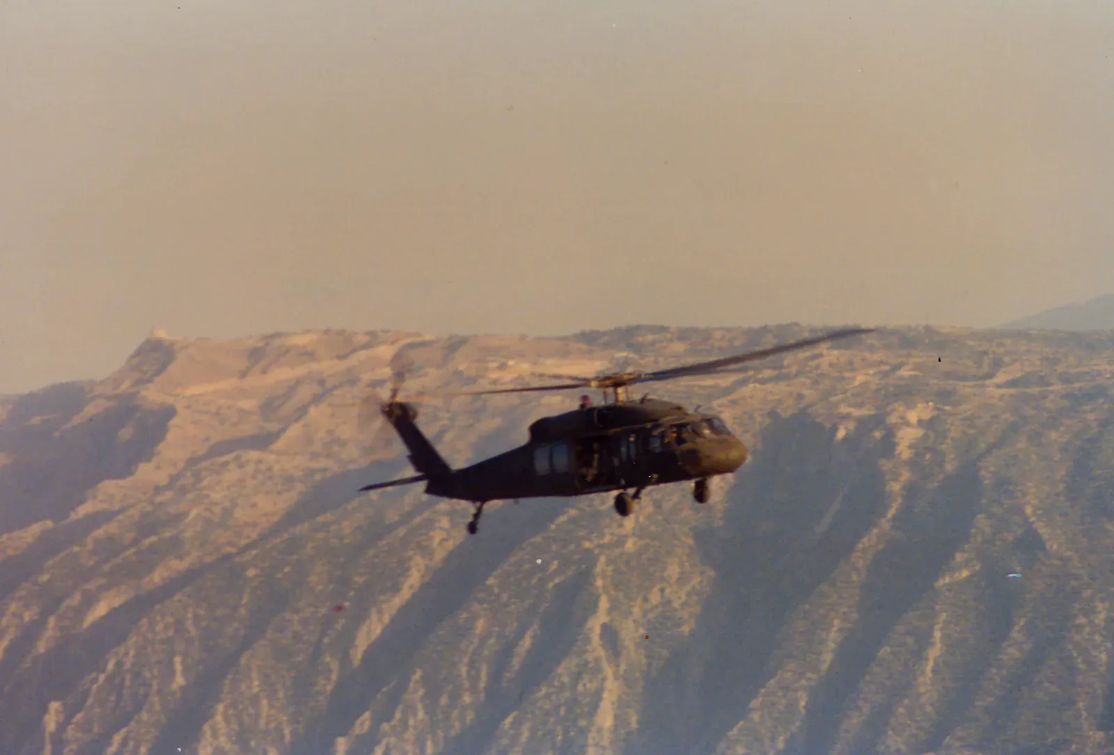 A Blackhawk helicopter over the Tigris river, photographed from a UH-1H