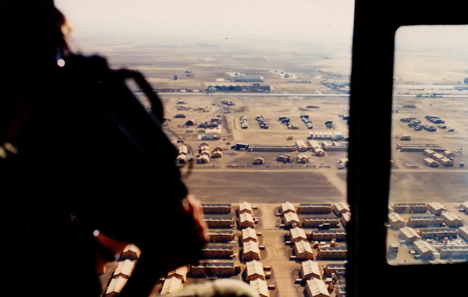 A camp seen from the air, photographed from a helicopter with a video camera in hand